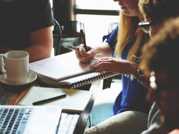 What are you most likely to be doing in a work meeting?
