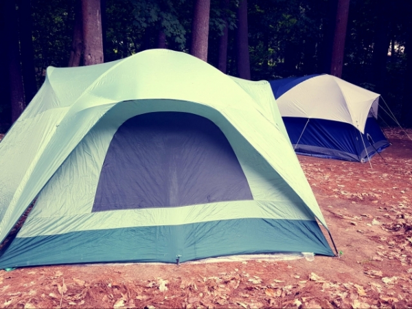 Where should you NEVER set up a temporary campsite?