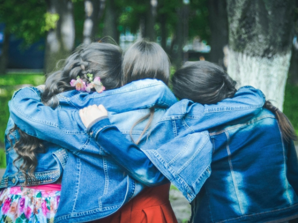 How many girls in the photo are wearing blue?